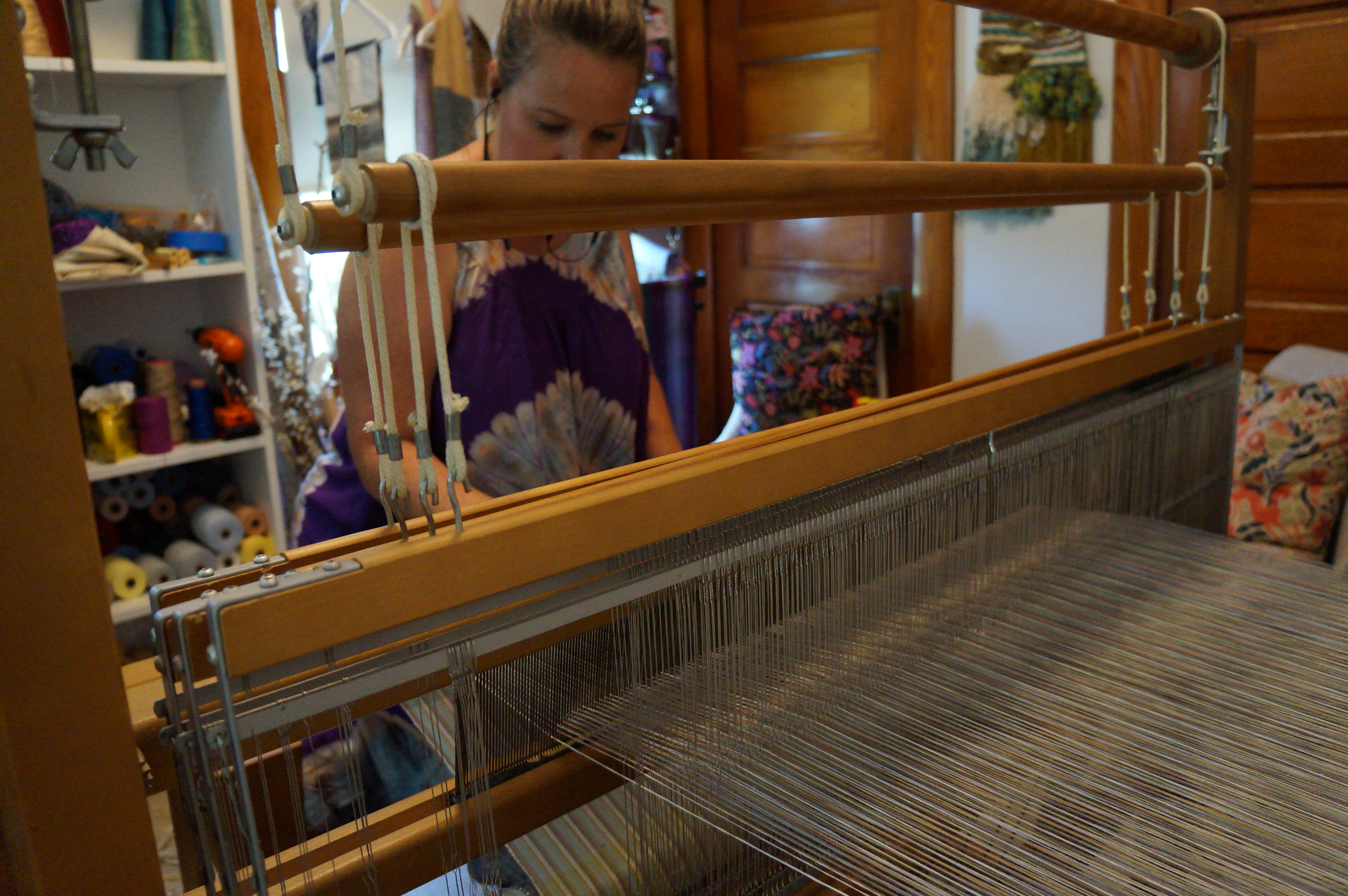 person sitting at a loom